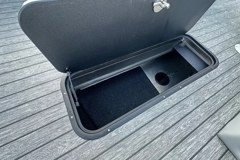 Slide: The Image of Open storage compartment on 2026 Ranger 223F boat deck. - 82