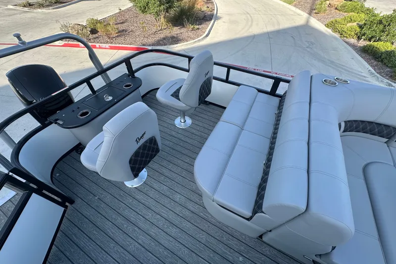 Slide: The Image of 2026 Ranger 223F boat interior with gray seating and steering console. - 77