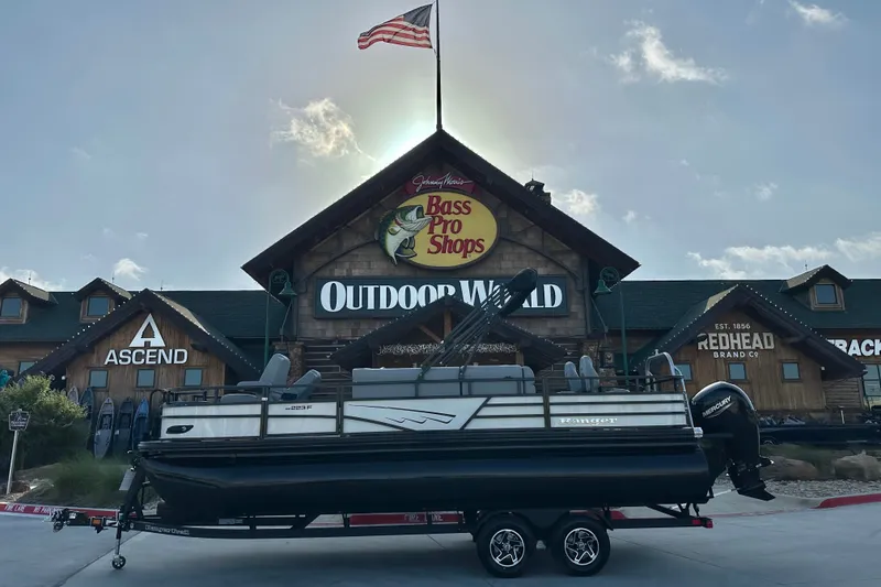The Image of 2026 Ranger 223F boat on trailer outside Bass Pro Shops Outdoor World. - 64