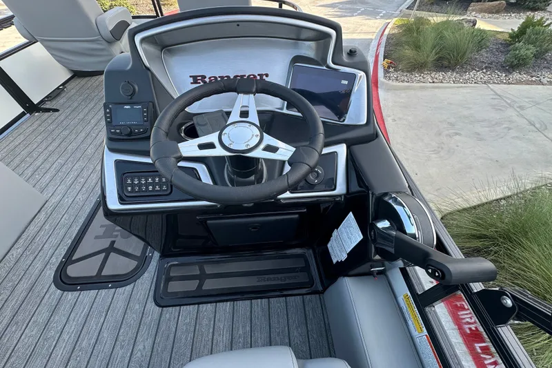 Slide: The Image of 2026 Ranger 223F boat dashboard with steering wheel and control panel. - 81