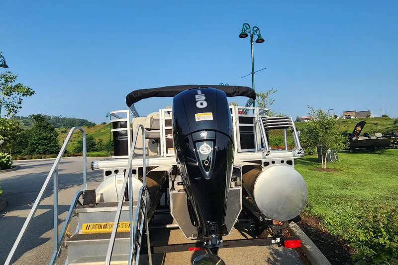 Slide: The Image of 2026 Sun Tracker Fishin' Barge 22 XP3 pontoon boat with powerful outboard motor. - 2