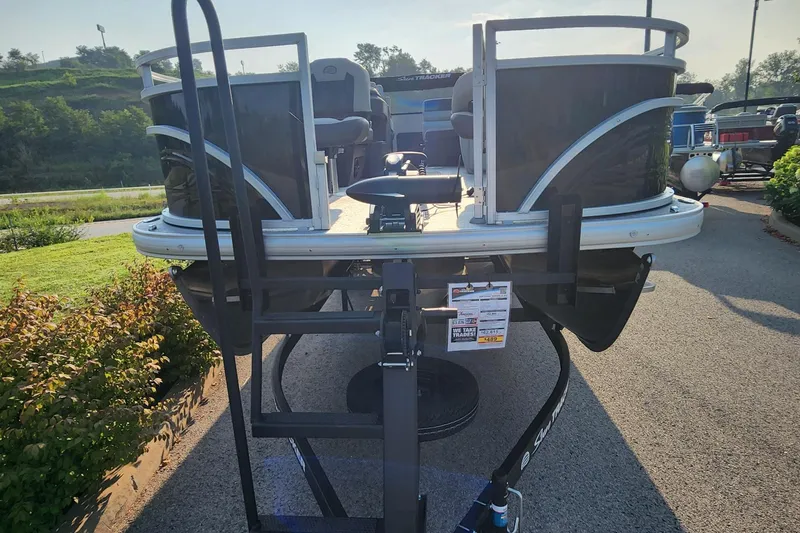 Slide: The Image of 2026 Sun Tracker Fishin' Barge 22 XP3 pontoon boat on trailer, outdoor display. - 6