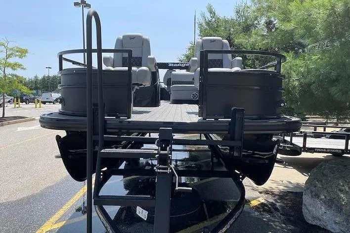Slide: The Image of 2026 Ranger 220F pontoon boat parked outdoors, featuring spacious seating and modern design. - 3