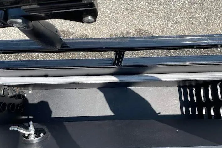 Slide: The Image of 2026 Ranger 220F boat interior detail with storage compartment and railing. - 7