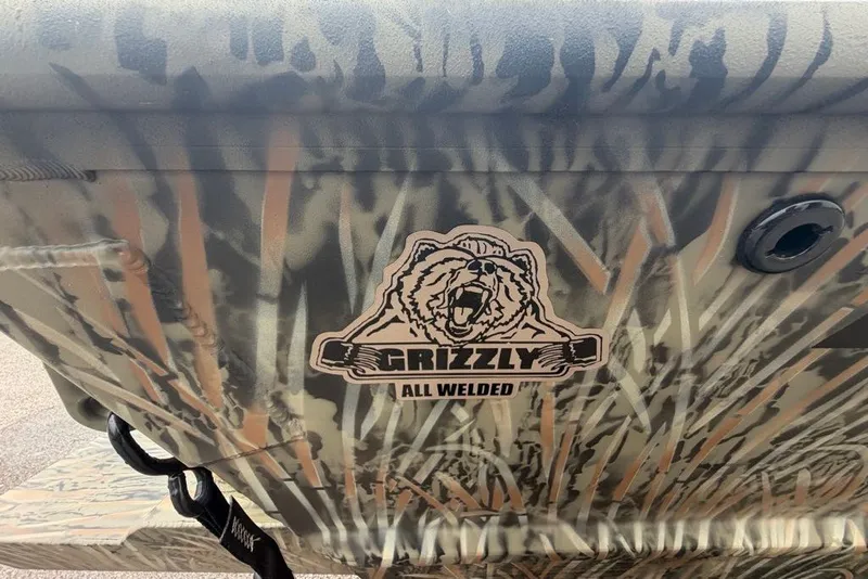 Slide: The Image of 2026 Tracker Grizzly 2072 CC boat with camo design and "All Welded" logo. - 7