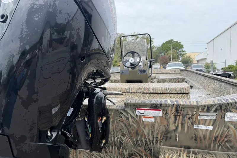 Slide: The Image of 2026 Tracker Grizzly 2072 CC boat with camouflage design and powerful outboard motor. - 5