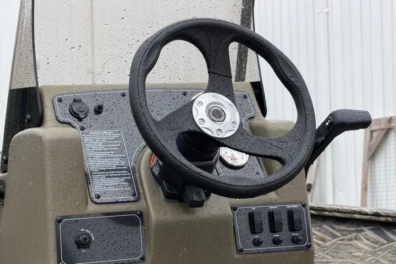 Slide: The Image of Steering console of 2026 Tracker Grizzly 2072 CC boat, featuring controls and gauges. - 4