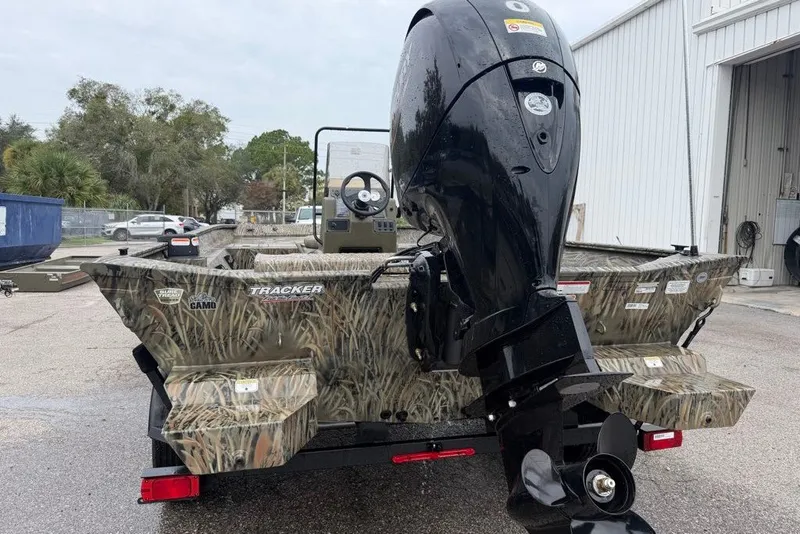Slide: The Image of 2026 Tracker Grizzly 2072 CC boat with camouflage design and powerful outboard motor. - 2
