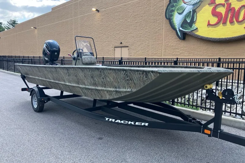 Slide: The Image of 2026 Tracker Grizzly 2072 CC boat on trailer, parked outside a store. - 3