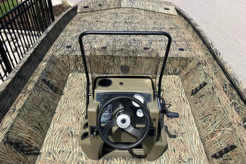 Slide: The Image of 2026 Tracker Grizzly 2072 CC boat with camouflage interior and steering console. - 6