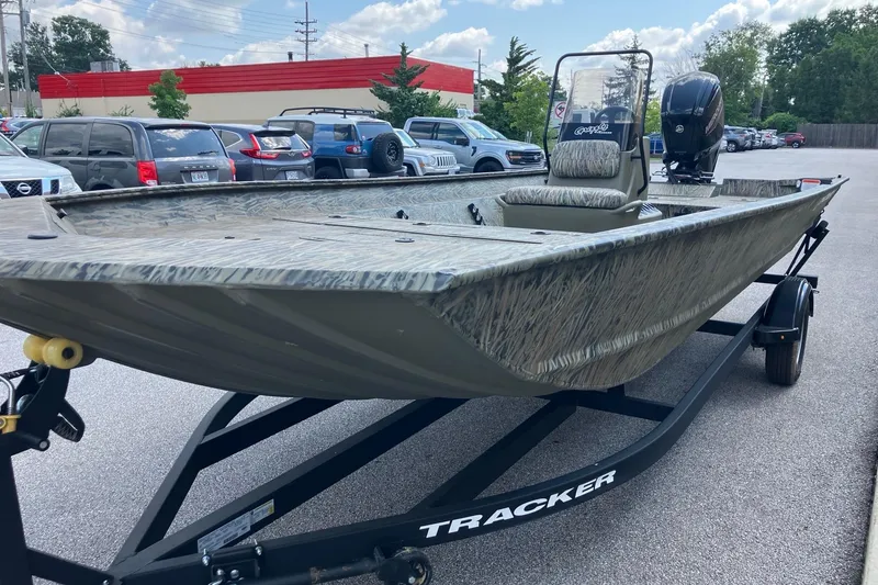 Slide: The Image of 2026 Tracker Grizzly 2072 CC boat on trailer in parking lot, camo design. - 4