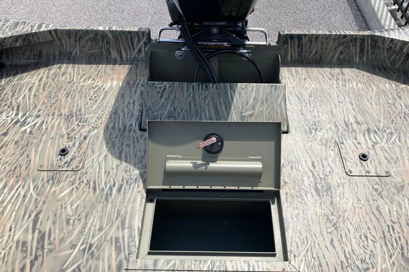 Slide: The Image of 2026 Tracker Grizzly 2072 CC boat interior with camo pattern and storage compartment. - 7