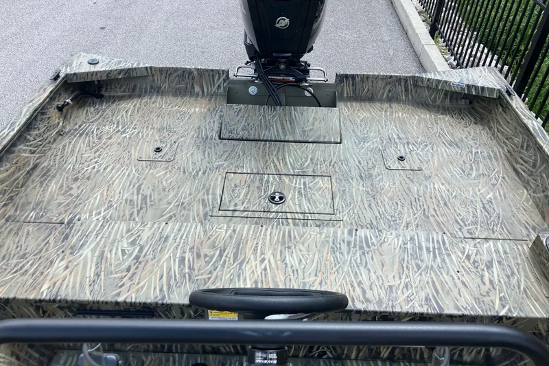 Slide: The Image of 2026 Tracker Grizzly 2072 CC boat with camouflage deck pattern and motor. - 5