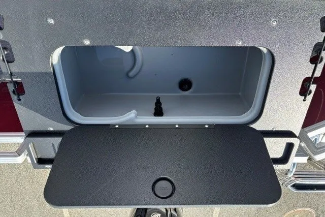 Slide: The Image of Open storage compartment on 2026 Sun Tracker SportFish 20 DLX boat. - 13