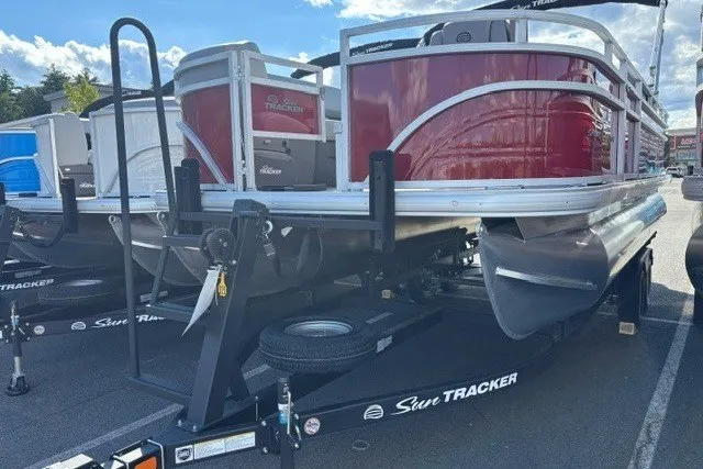The Image of 2026 Sun Tracker SportFish 20 DLX pontoon boat on trailer, red and silver design. - 0