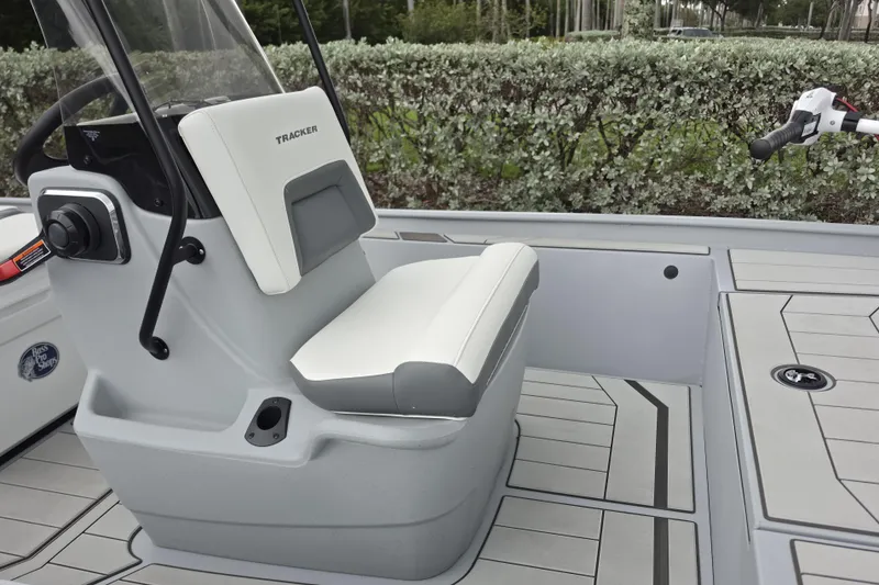 Slide: The Image of 2026 Tracker Bass Tracker Classic CC boat interior with white seating and control panel. - 8