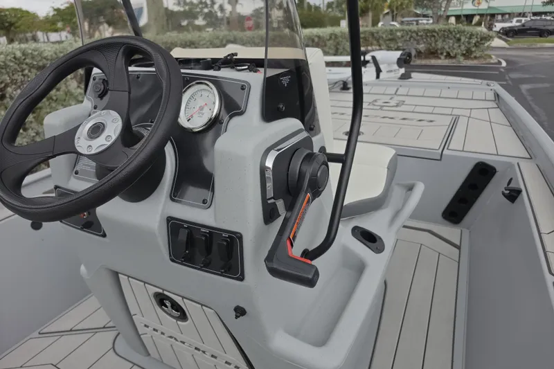Slide: The Image of 2026 Tracker Bass Tracker Classic CC boat console with steering wheel and controls. - 4