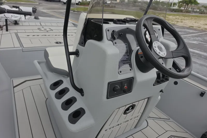 Slide: The Image of 2026 Tracker Bass Tracker Classic CC boat console with steering wheel and controls. - 5