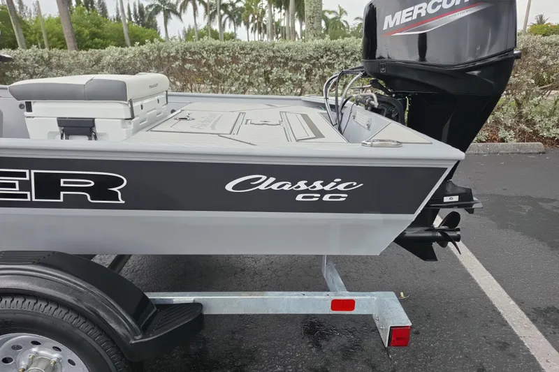 Slide: The Image of 2026 Tracker Bass Tracker Classic CC boat with Mercury engine in parking lot. - 11