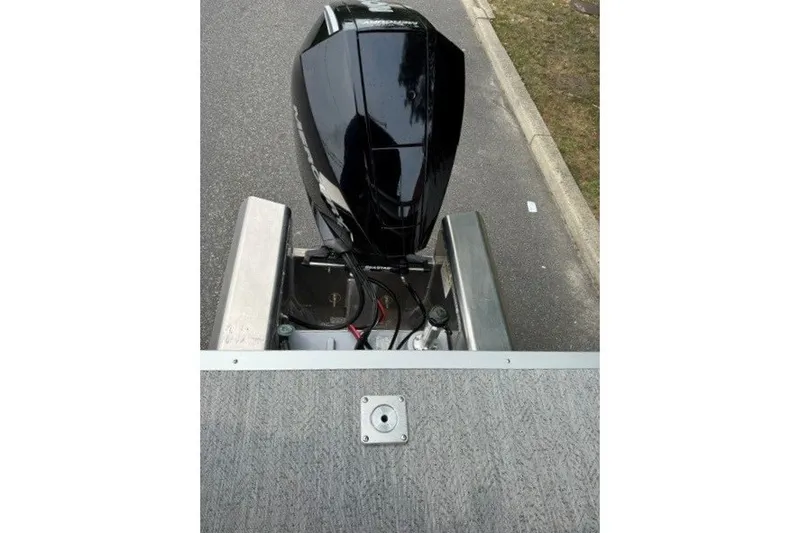 Slide: The Image of 2026 Sun Tracker Fishin' Barge 22 XP3 outboard motor on a trailer. - 21