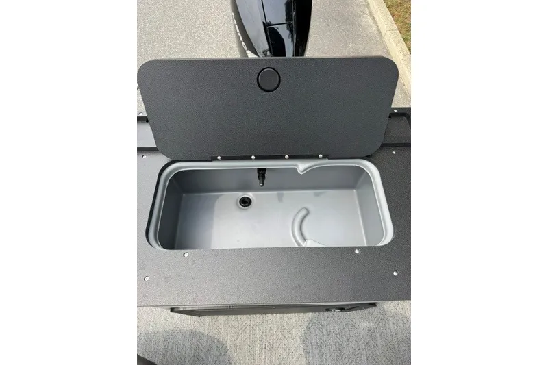 Slide: The Image of Open storage compartment on 2026 Sun Tracker Fishin' Barge 22 XP3 boat. - 17
