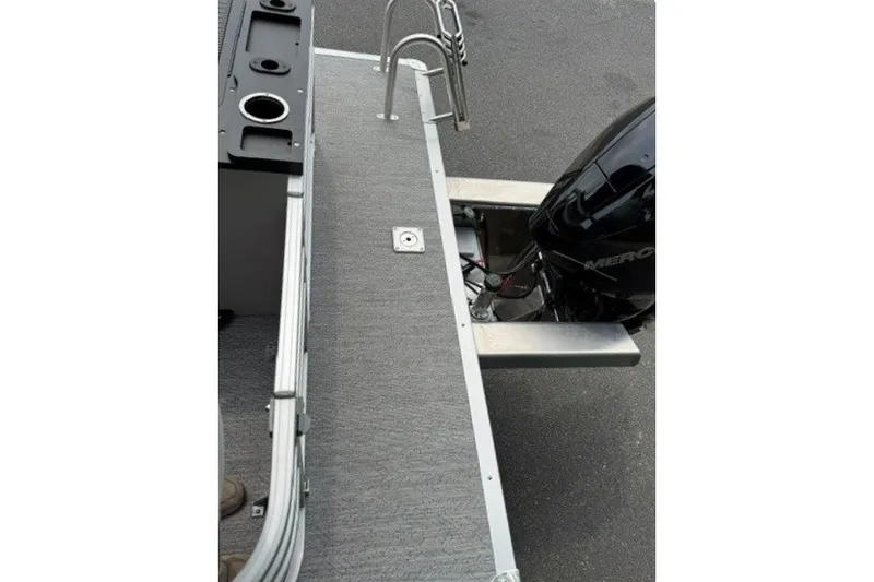 Slide: The Image of 2026 Sun Tracker Fishin' Barge 22 XP3 deck with motor and ladder. - 20