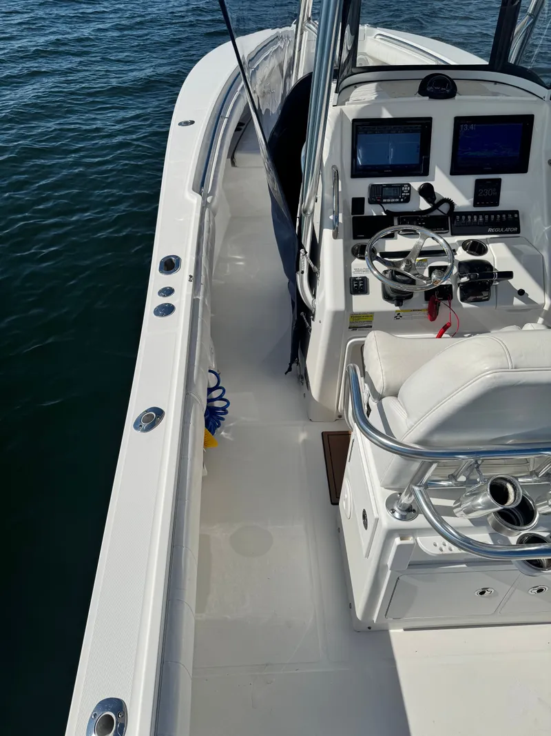 Slide: The Image of The image shows the cockpit of a 2015 Regulator 25 boat with modern instruments. - 18