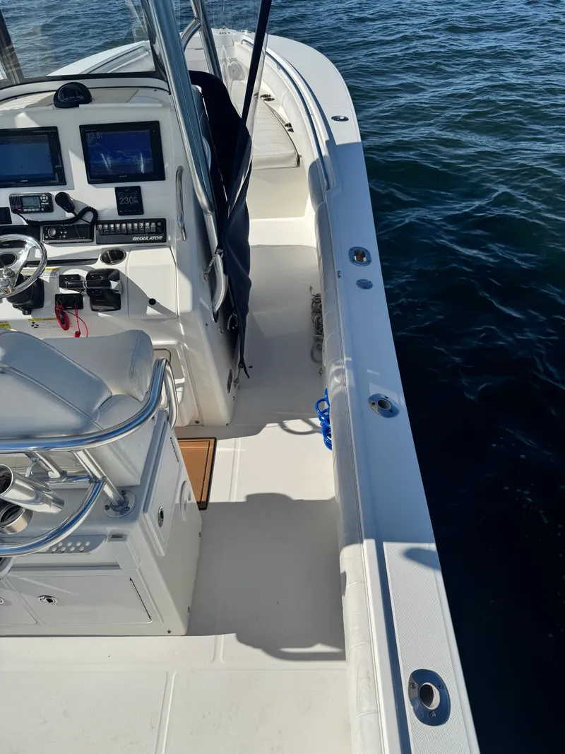 Slide: The Image of The image shows the deck of a 2015 Regulator 25 boat with a helm console and electronics. - 19