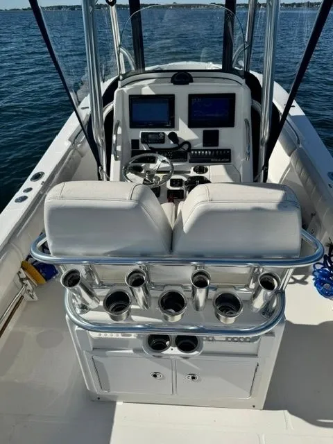 Slide: The Image of The image shows the cockpit of a 2015 Regulator 25 boat with a white seat and helm console. - 9
