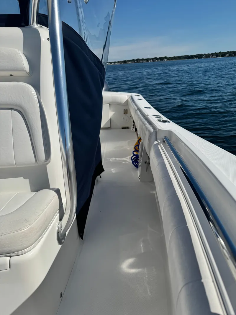 Slide: The Image of The image shows the deck of a 2015 Regulator 25 boat on calm water. - 21