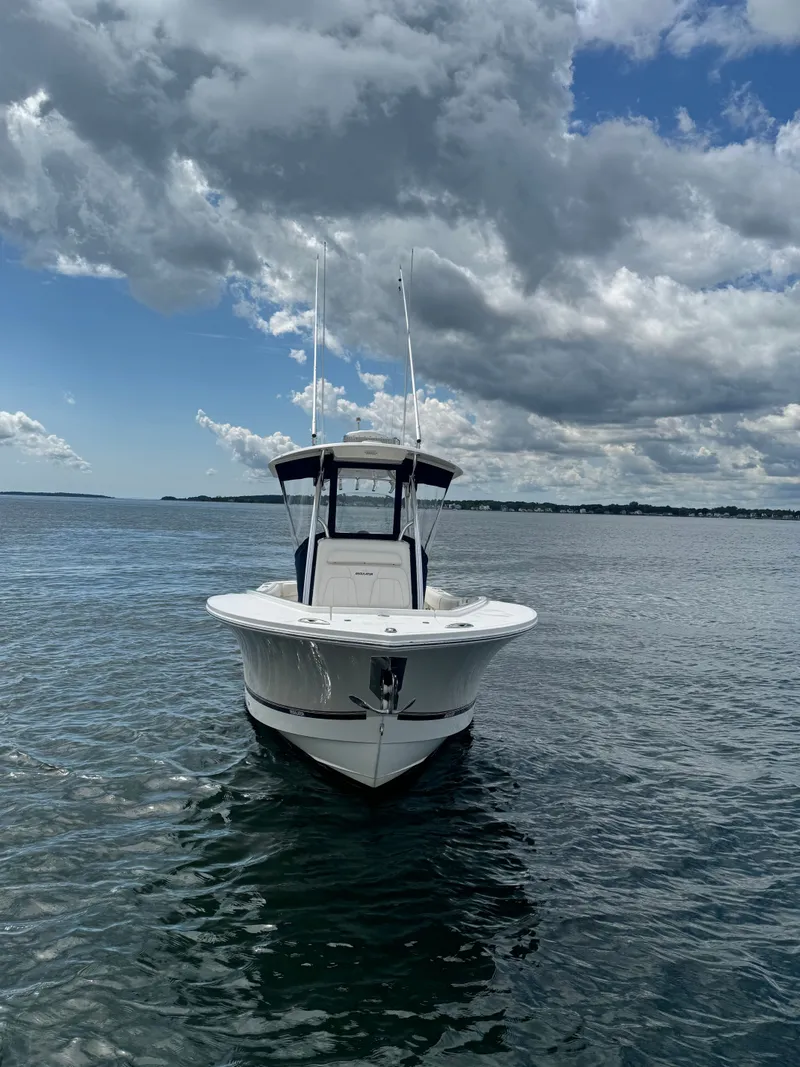 Slide: The Image of A 2015 Regulator 25 boat on calm water under a cloudy sky. - 5