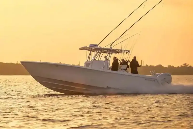 Slide: The Image of Manufacturer Provided Image: 2026 Contender 35 ST boat cruising at sunset on calm waters. - 4