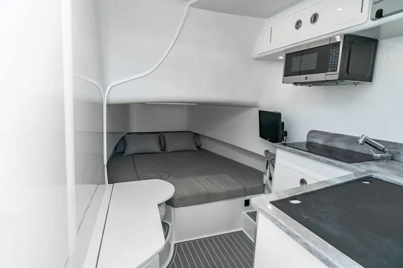 Slide: The Image of Manufacturer Provided Image: Interior of 2026 Contender 39 Fisharound boat with bed, microwave, and kitchenette. - 10