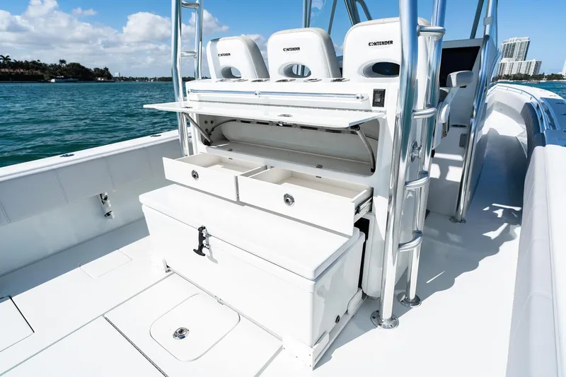 Slide: The Image of Manufacturer Provided Image: 2026 Contender 39 Fisharound boat interior with storage compartments and seating on open water. - 6