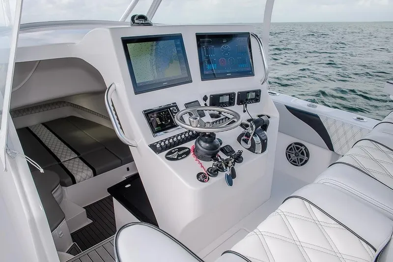 Slide: The Image of Manufacturer Provided Image: 2026 Contender 39 Fisharound boat cockpit with advanced navigation systems and luxurious seating. - 7