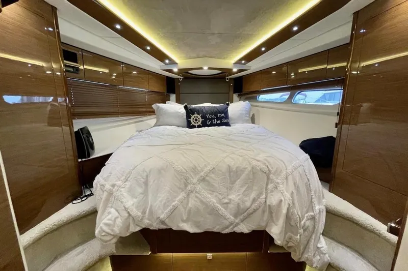 Slide: The Image of Luxurious 2018 Cruisers Yachts 45 Cantius bedroom with elegant wood finishes and cozy bedding. - 14