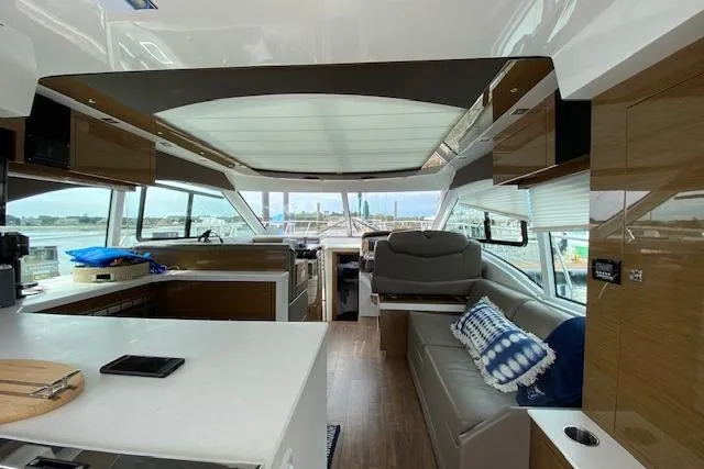 Slide: The Image of Luxurious interior of 2018 Cruisers Yachts 45 Cantius with modern seating and panoramic windows. - 6