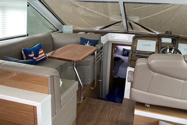 Slide: The Image of Interior of 2018 Cruisers Yachts 45 Cantius with seating, table, and navigation equipment. - 10
