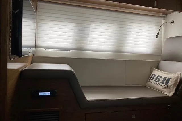 Slide: The Image of Interior of 2018 Cruisers Yachts 45 Cantius with cushioned seating and decorative pillow. - 15