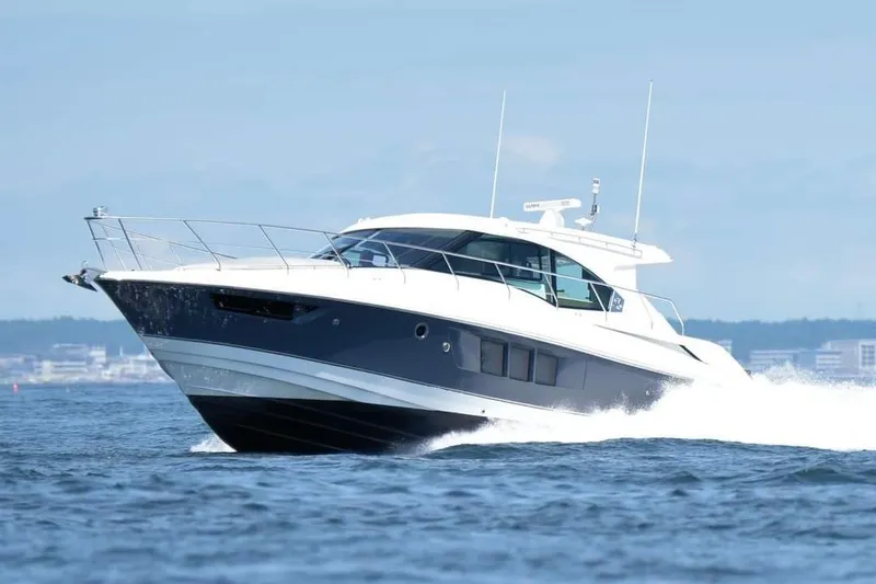 The Image of 2018 Cruisers Yachts 45 Cantius cruising on open water, showcasing sleek design and performance. - 1