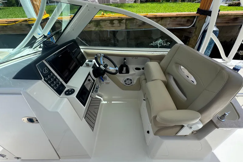 Slide: The Image of 2017 Sailfish 325 DC boat cockpit with steering wheel and control panel. - 10