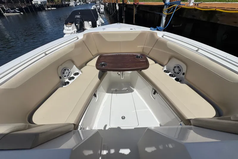 Slide: The Image of Spacious seating area on 2017 Sailfish 325 DC boat with table and cup holders. - 16