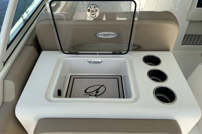 Slide: The Image of Sailfish 325 DC 2017 boat interior with storage compartment and cup holders. - 19