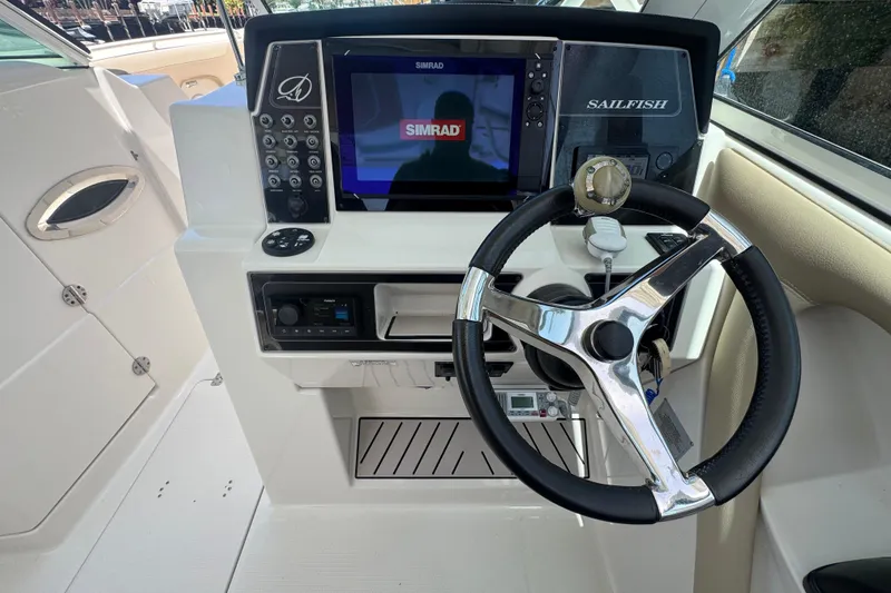 Slide: The Image of Steering console of 2017 Sailfish 325 DC boat with Simrad display and controls. - 13