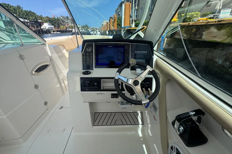 Slide: The Image of 2017 Sailfish 325 DC boat cockpit with steering wheel and navigation controls. - 12