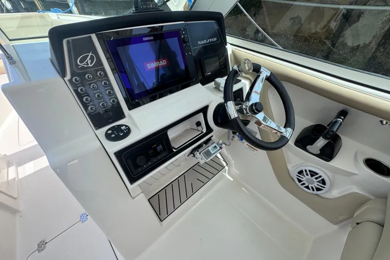 Slide: The Image of Steering console of a 2017 Sailfish 325 DC boat with Simrad navigation system. - 11
