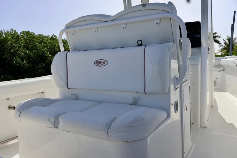 Slide: The Image of 2018 Sea Hunt Gamefish 27 Coffin Box boat interior with white seating and console. - 10