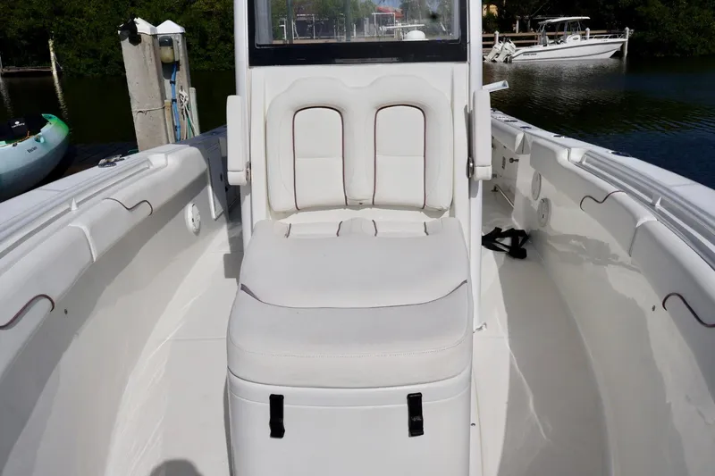Slide: The Image of 2018 Sea Hunt Gamefish 27 Coffin Box boat interior with white seating and storage. - 19
