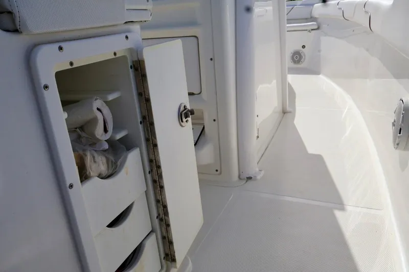 Slide: The Image of 2018 Sea Hunt Gamefish 27 Coffin Box interior storage compartment with open door. - 16