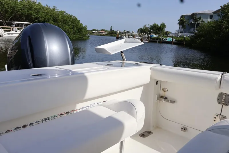 Slide: The Image of 2018 Sea Hunt Gamefish 27 Coffin Box boat interior with engine, dockside view. - 7